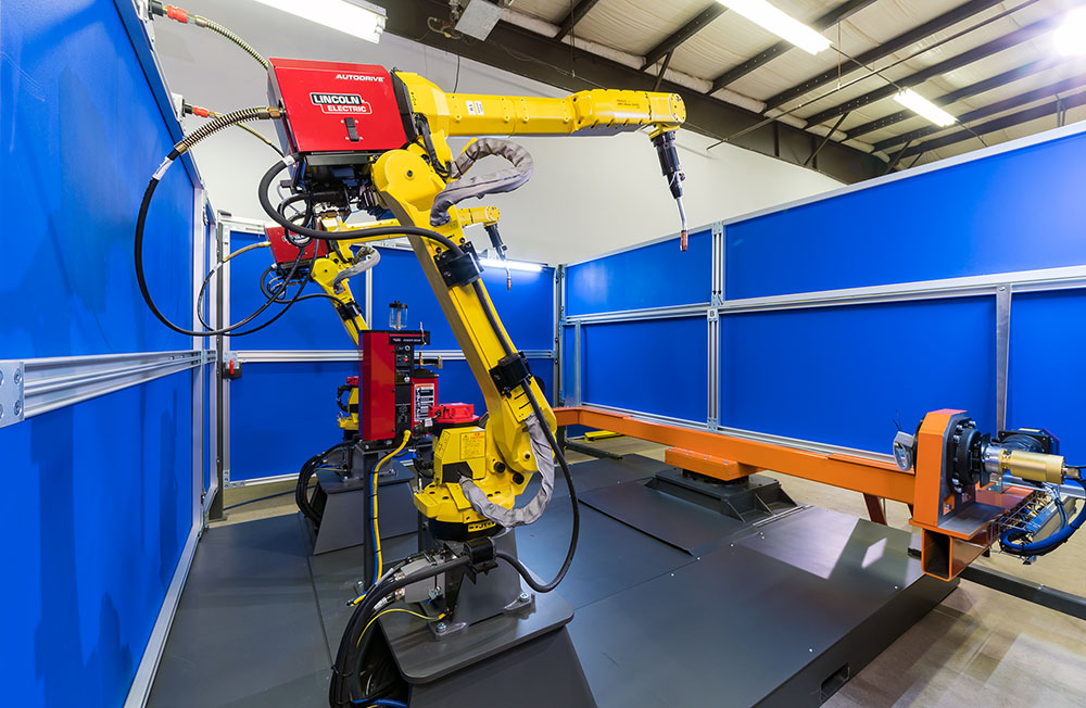 welding robots inside the preconfigured welding automation cell from TranTek Systems